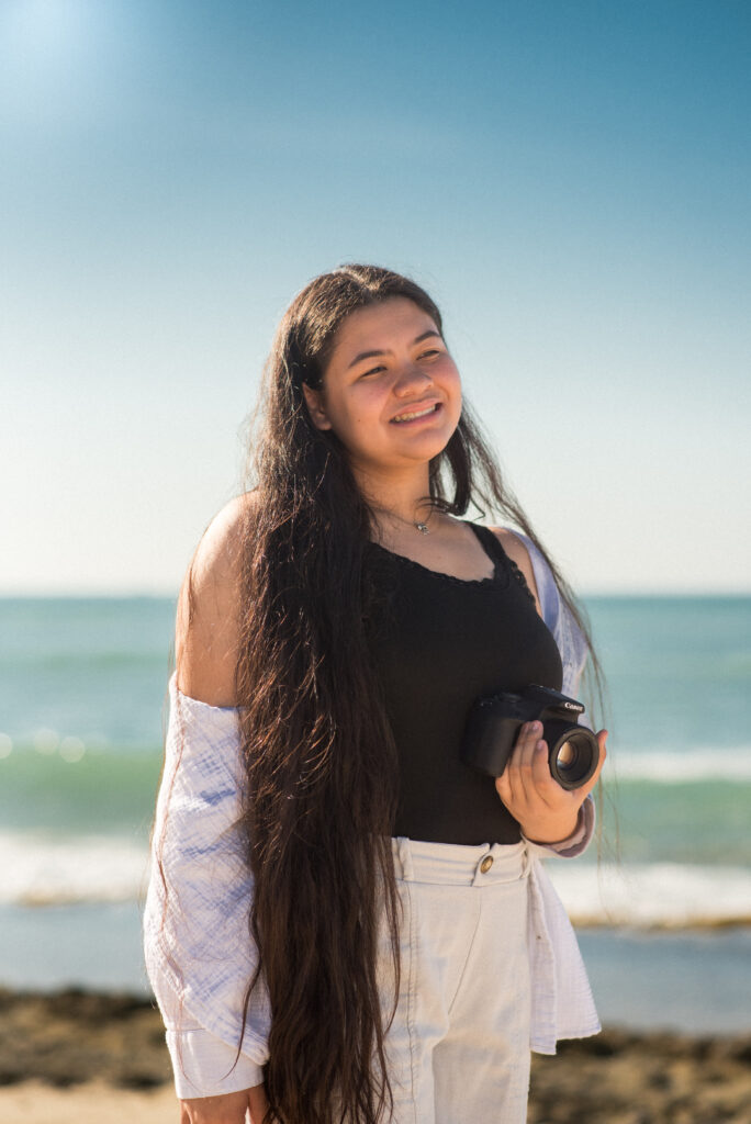Warm, natural light portrait of Kadi symbolizing her transformation through photography mentorship.